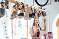 Woman looking at shoes dangling from the ceiling in store