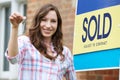 Excited Woman Outside New Home Holding Keys