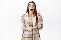 Excited woman pitching an idea, raising finger and gasping have interesting suggestion, think-up great plan, sharing her Royalty Free Stock Photo