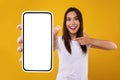 Excited woman pointing at white empty smartphone screen