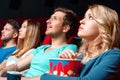 Excited woman with popcorn in cinema Royalty Free Stock Photo