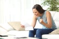 Excited woman reading good news in letter