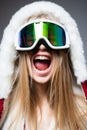 Excited woman in ski goggles. Close up winter portrait of young amazing girl with snow goggles. Royalty Free Stock Photo