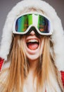 Excited woman in ski goggles. Close up winter portrait of young amazing girl with snow goggles. Royalty Free Stock Photo