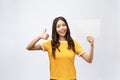 Excited woman thumbs up with blank poster sign. Young woman mixed asian caucasian ethnicity. Royalty Free Stock Photo