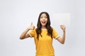 Excited woman thumbs up with blank poster sign. Young woman mixed asian caucasian ethnicity. Royalty Free Stock Photo