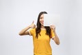 Excited woman thumbs up with blank poster sign. Young woman mixed asian caucasian ethnicity. Royalty Free Stock Photo