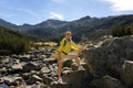 Excited woman walking through landscape outdoors. An active girl enjoys her Royalty Free Stock Photo