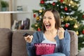 Excited woman watching tv on christmas