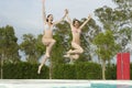 Excited Women Jumping In Pool