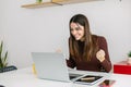 Excited young businesswoman feeling happy after receiving good news on email. Royalty Free Stock Photo