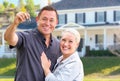 Excited Young Adult Couple With House Keys In Front of Beautiful Home Royalty Free Stock Photo