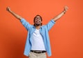 Excited young african american man winner raising arms with clenched fists and celebrating success Royalty Free Stock Photo