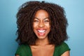 Excited young african woman laughing with mouth open on blue background Royalty Free Stock Photo