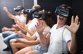 Excited man experiencing with friends virtual reality