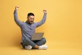 Excited Young Asian Man Using Laptop And Celebrating Success With Raised Hands Royalty Free Stock Photo