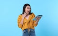 Excited young asian woman using tablet computer isolated on blue background Royalty Free Stock Photo