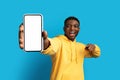 Excited young black guy showing smartphone with mockup Royalty Free Stock Photo