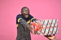 excited young black man feeling super excited receiving a present from someone