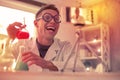 Excited young boy openly laughing doing chemistry