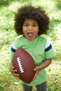 Excited Young Boy Playing American Football In Park Royalty Free Stock Photo