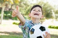 Excited Young Boy Playing with Soccer Ball and Thumbs Up Outdoors Royalty Free Stock Photo