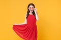 Excited young brunette woman girl in red summer dress, eyeglasses posing isolated on yellow wall background studio Royalty Free Stock Photo