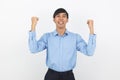 Excited young business Asian man raising his fists with happy delighted face, celebrating success isolated on white background. Royalty Free Stock Photo