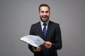 Excited young business man in classic black suit shirt tie posing isolated on grey wall background. Achievement career Royalty Free Stock Photo