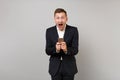 Excited young business man keeping mouth open wide, looking surprised using mobile phone typing sms message isolated on Royalty Free Stock Photo