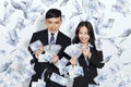 Excited young business man and woman under the money rain Royalty Free Stock Photo