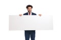 Excited young businessman presenting white empty board and smiling Royalty Free Stock Photo