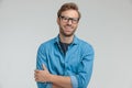 Excited young casual man laughing and crossing arms