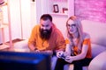 Excited young couple playing online video games together Royalty Free Stock Photo