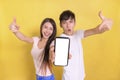 Excited Young  couple pointing at blank  smartphone screen Royalty Free Stock Photo