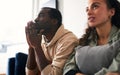 Excited Young Couple Relaxing At Home Sitting On Sofa Whilst Watching Sport On TV Together Royalty Free Stock Photo