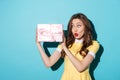 Excited young girl in dress looking at a present box Royalty Free Stock Photo