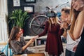 Excited young girl testing virtual reality headset while her friends watching, laughing and supporting her. Group of Royalty Free Stock Photo