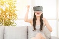Excited young girl winning VR video game