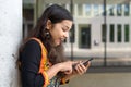 Excited young Indian girl exclaiming at a sms