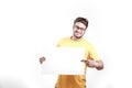 Excited Young Indian man on spectacles and showing blank poster in hand Royalty Free Stock Photo