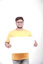 Excited Young Indian man on spectacles and showing blank poster in hand Royalty Free Stock Photo