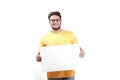 Excited Young Indian man on spectacles and showing blank poster in hand Royalty Free Stock Photo