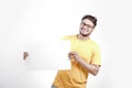 Excited Young Indian man on spectacles and showing blank poster in hand Royalty Free Stock Photo