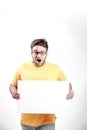 Excited Young Indian man on spectacles and showing blank poster in hand Royalty Free Stock Photo