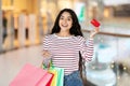 Excited young indian woman enjoying shopping, showing credit card Royalty Free Stock Photo