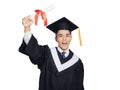 Excited young man in  black graduation gown and cap holding a diploma Royalty Free Stock Photo