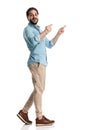 excited young man in denim shirt pointing fingers and smiling Royalty Free Stock Photo