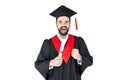 Excited young man in graduation hat holding diploma and triumphing Royalty Free Stock Photo