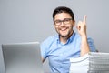 Excited young man with laptop pointing finger up Royalty Free Stock Photo